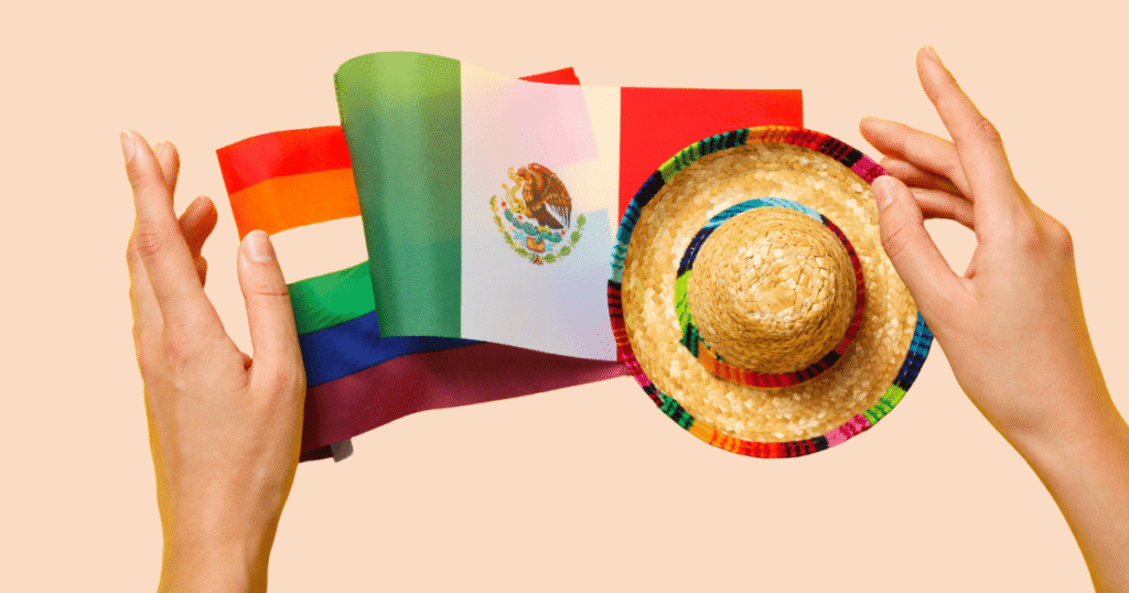 Manos sosteniendo un gorro de charro mexicano, una bandera de México y una bandera arcoíris LGTBIQ+ sobre un fondo difuminado.