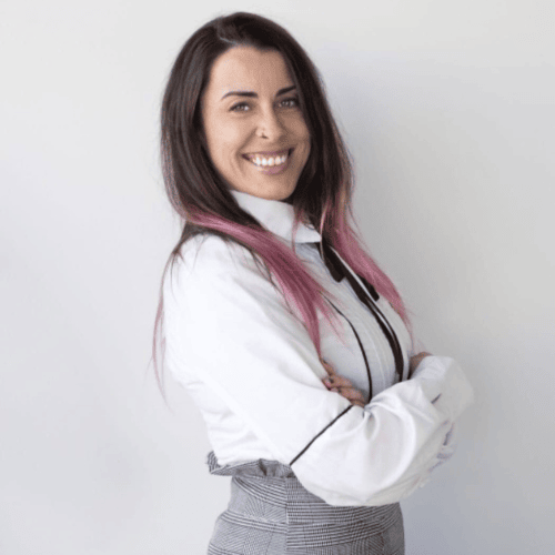 Psicóloga Maite sonriendo ampliamente de lado, transmitiendo calidez.